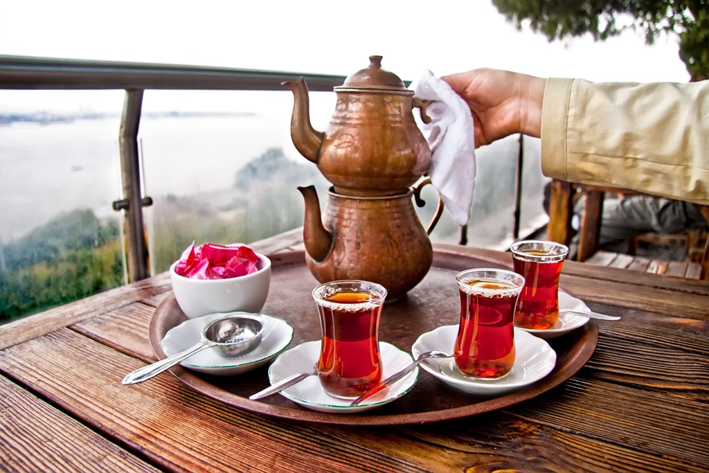 Drinking_Traditional_Turkish_Tea_with_Turkish_tea_cup_and_copper_tea_pot.jpg